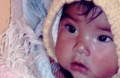 A Quechua baby on the back of a mother of one of the clinic’s patients. Photo by Barrie Pedroza